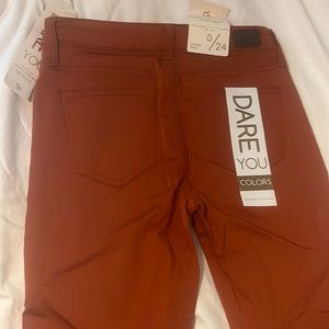 Here are some jeans, their a orange kinda red color and a size 0/24.